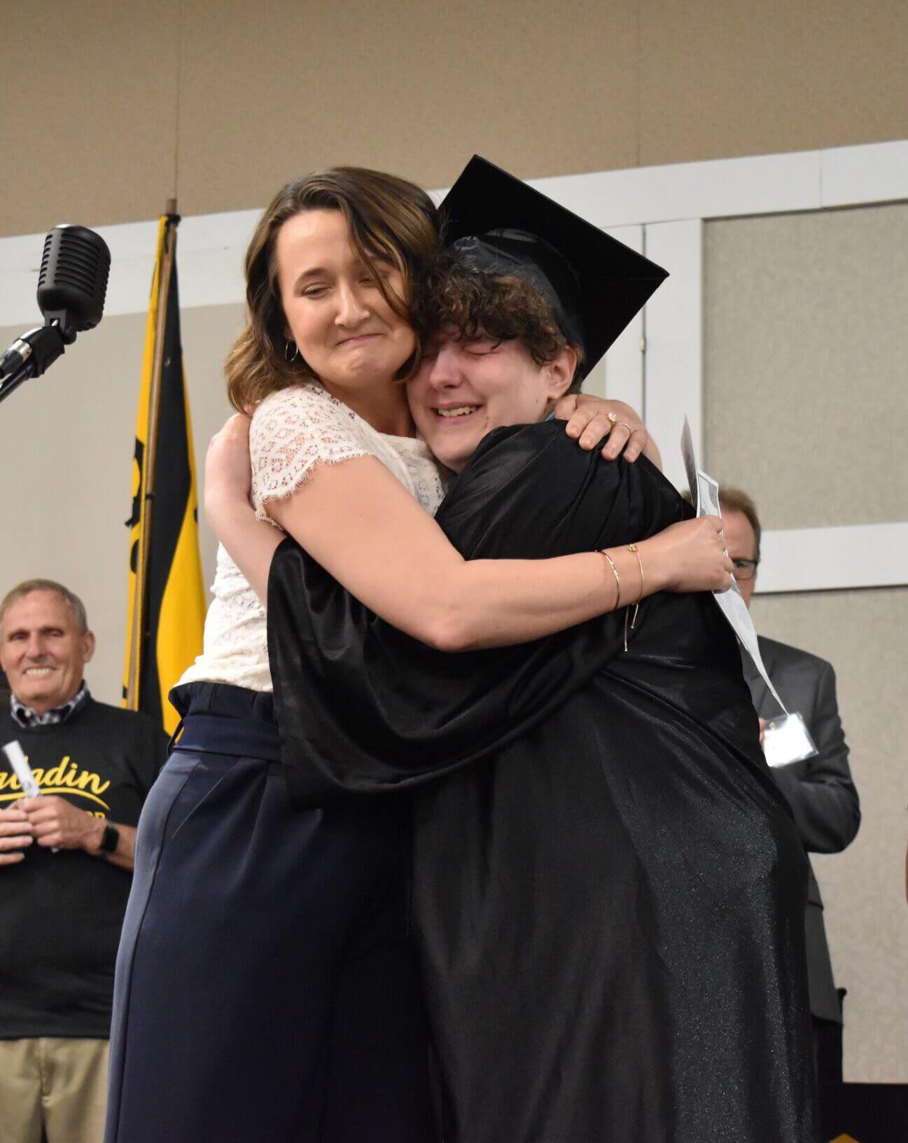 graduate hugging